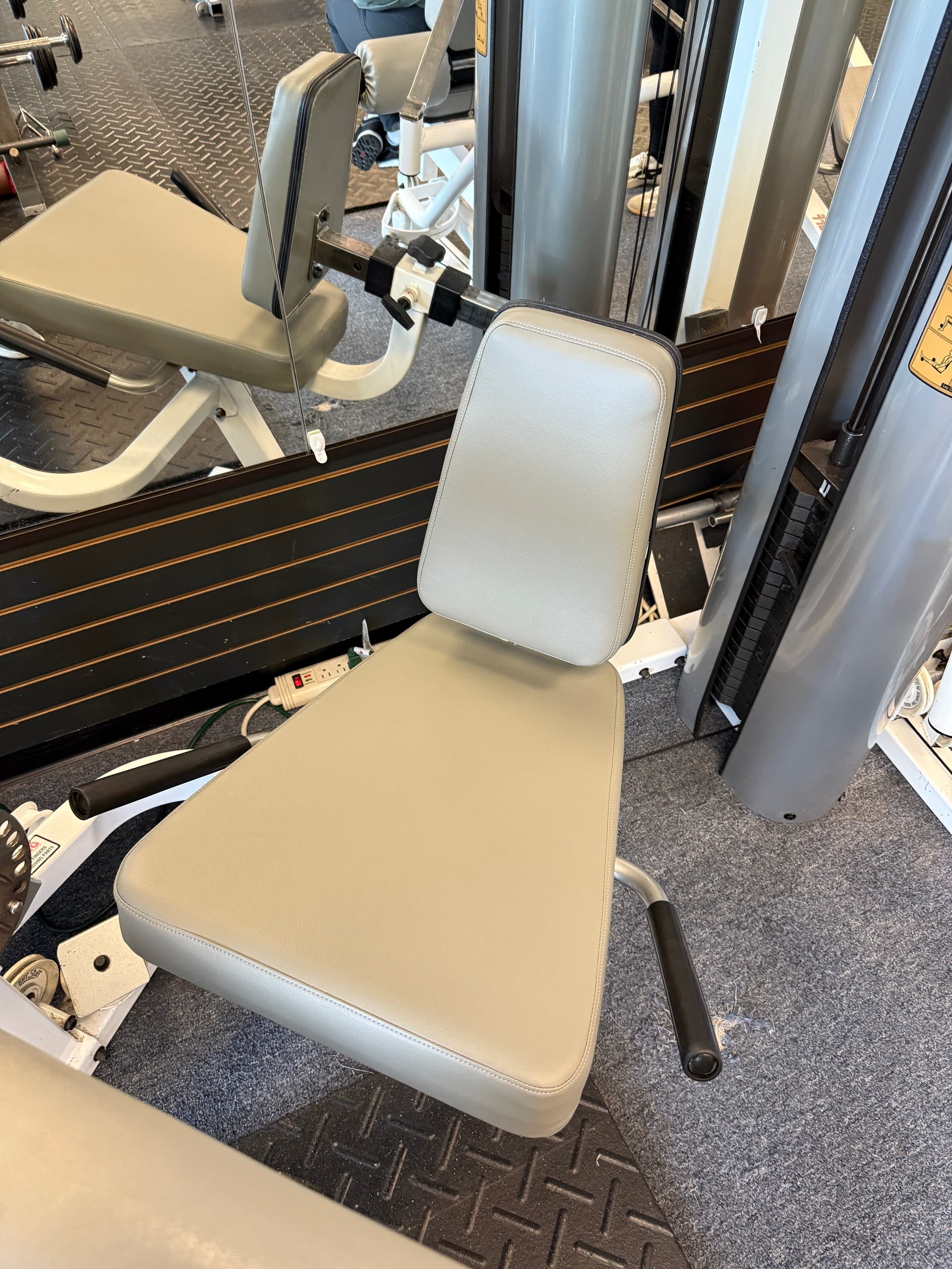 Commercial gym strength station with restored gray upholstery