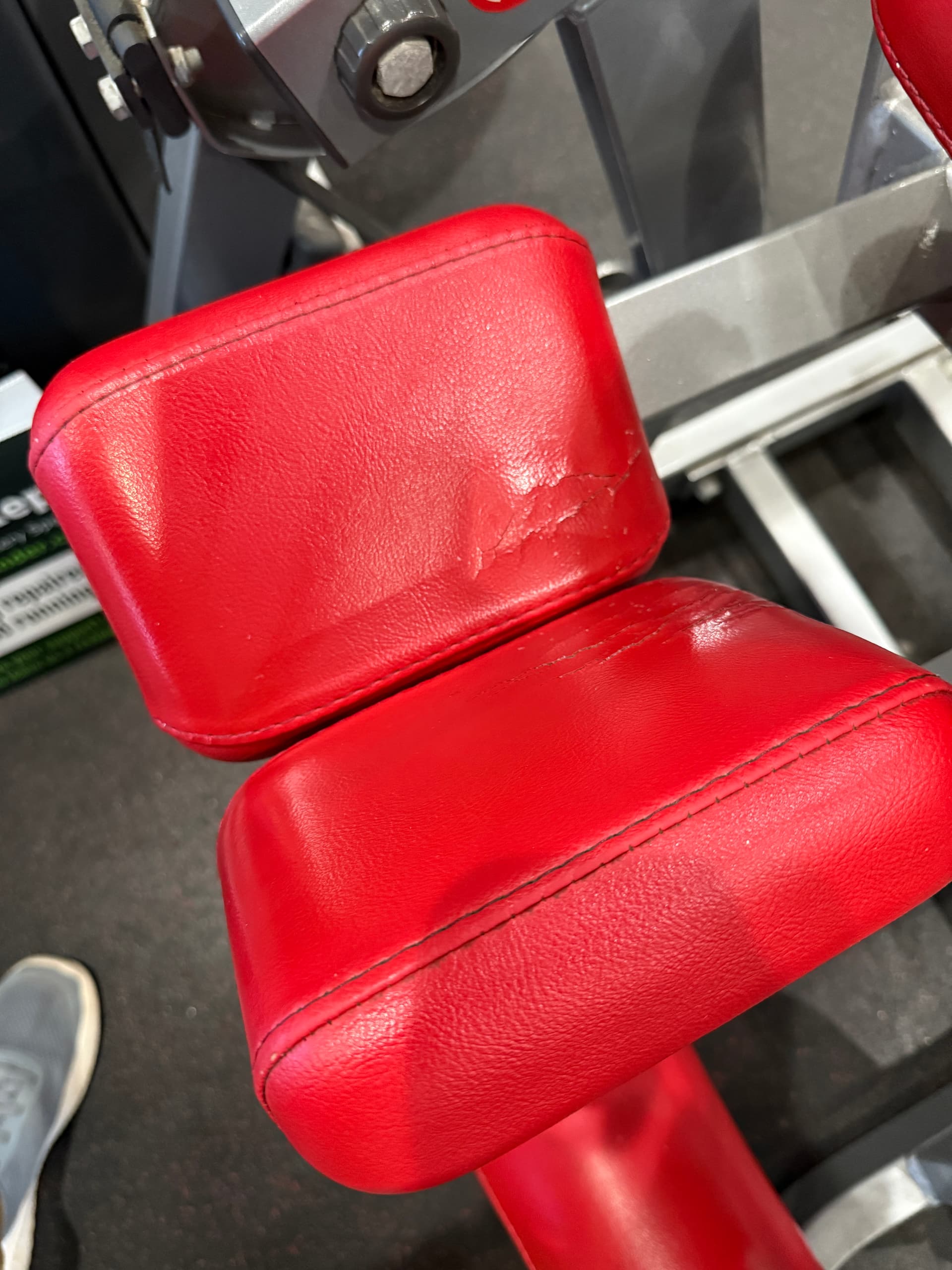 Commercial red strength station before upholstery restoration