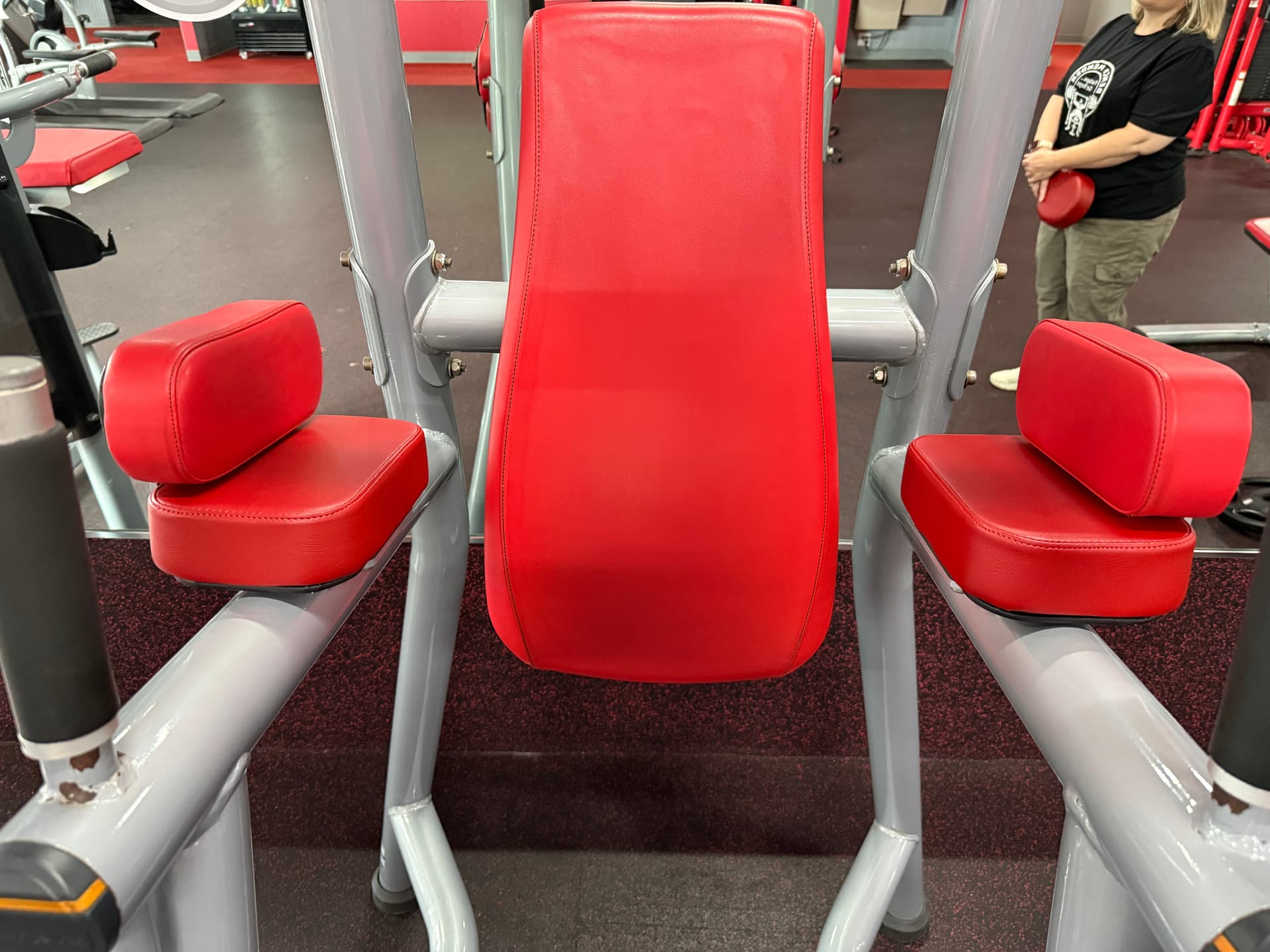 Freshly restored red upholstery on a commercial gym machine